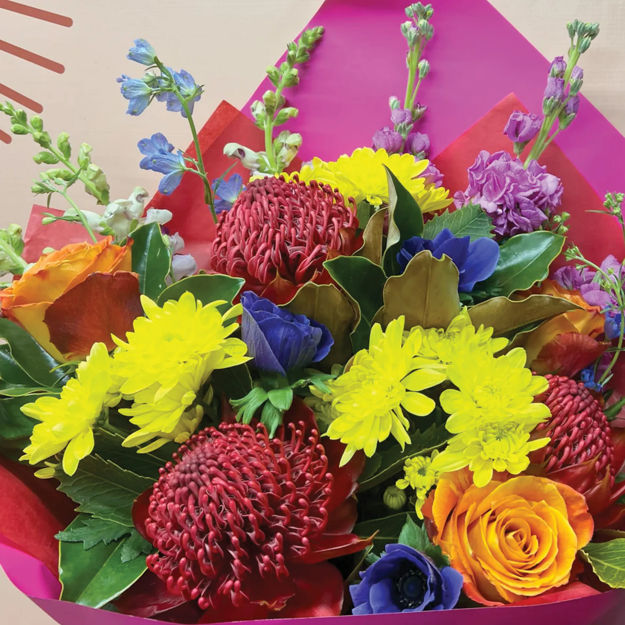 A colourful bouquet of yellow, orange, red, and purple flowers